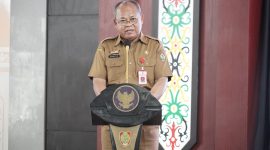 SAMBUTAN: Pelaksana Harian (Plh) Asisten Pemerintahan dan Kesejahteraan Rakyat, Sekretariat Daerah Provinsi Kalteng Maskur saat membacakan sambutan Gubernur saat Rakor Pengembangan Kabupaten dan Kota Tanggap Ancaman Narkotika yang digelar di Aula Jayang Tingang, Selasa (6/5).(IST)