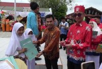 PENGHARGAAN : Kepala Seksi Peserta Didik dan Prasarana Disdik Kotim, M Ikram Muhajir, didampingi Kepala SMPN 4 Sampit, Anjar Subiantoro saat memberikan penghargaan kepada salah satu siswa, Selasa, (24/6/2025).(IST)