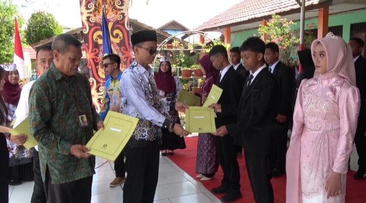 MENYERAHKAN: Kepala SMPN 4 Sampit, Anjar Subiantoro saat menyerahkan penghargaan kepada salah satu murid saat perpisahan beberapa waktu lalu.(IST)
