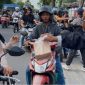 BERBAGI : Ketua PWI Kalteng, M. Zainal,saat membagikan takjil kepada masyarakat yang melintas di depan Kantor PWI Kalteng, Jalan RTA Milono, Palangka Raya, Sabtu (7/3/2026) sore.